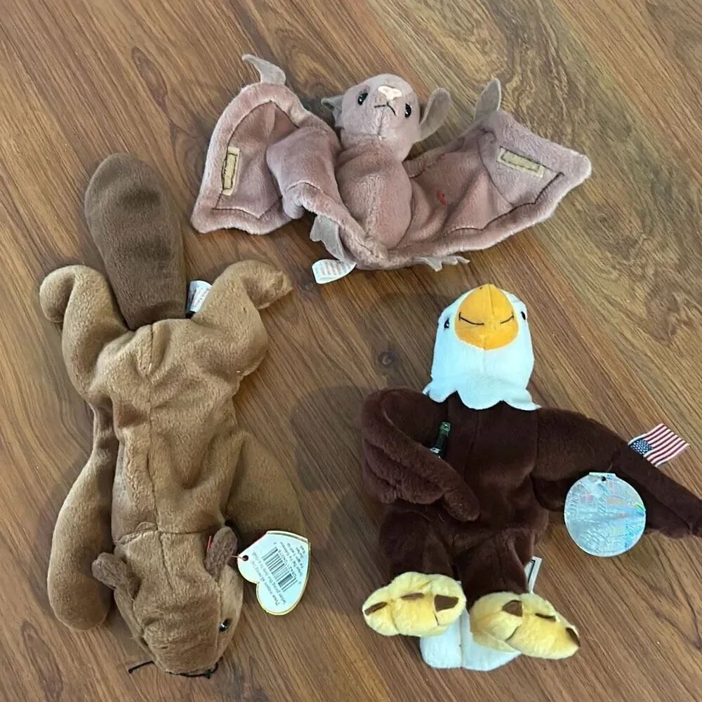 A lot of 3 plush beanie babies and one Coca-Cola bald eagle